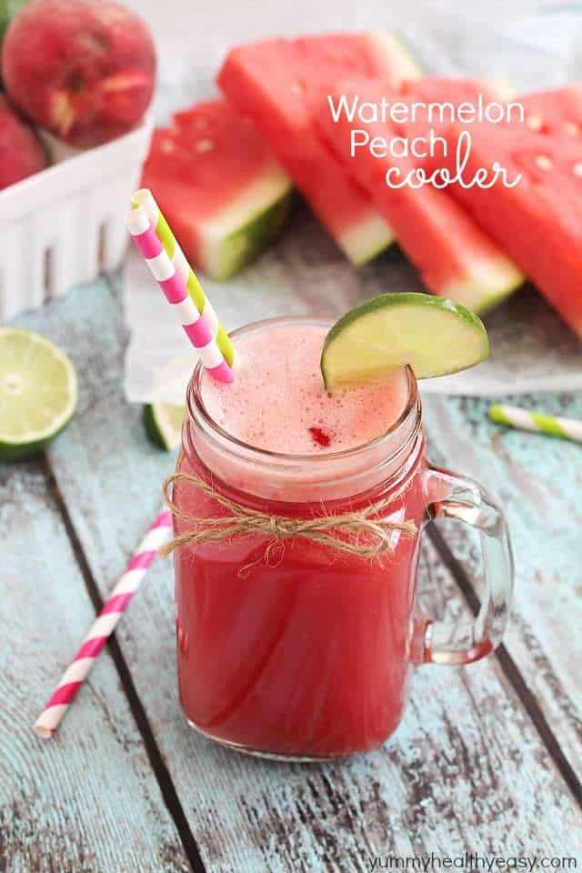 Watermelon Peach Cooler in a clear mason jar with fresh watermelon in the background. 