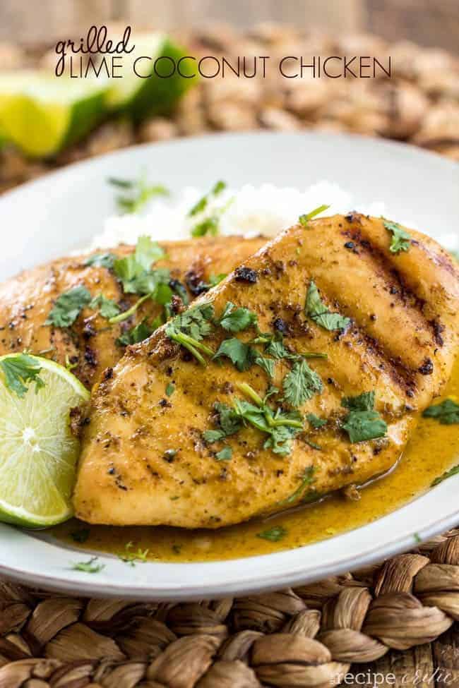 Grilled Lime Coconut Chicken on a white plate with fresh cut limes on the side. 