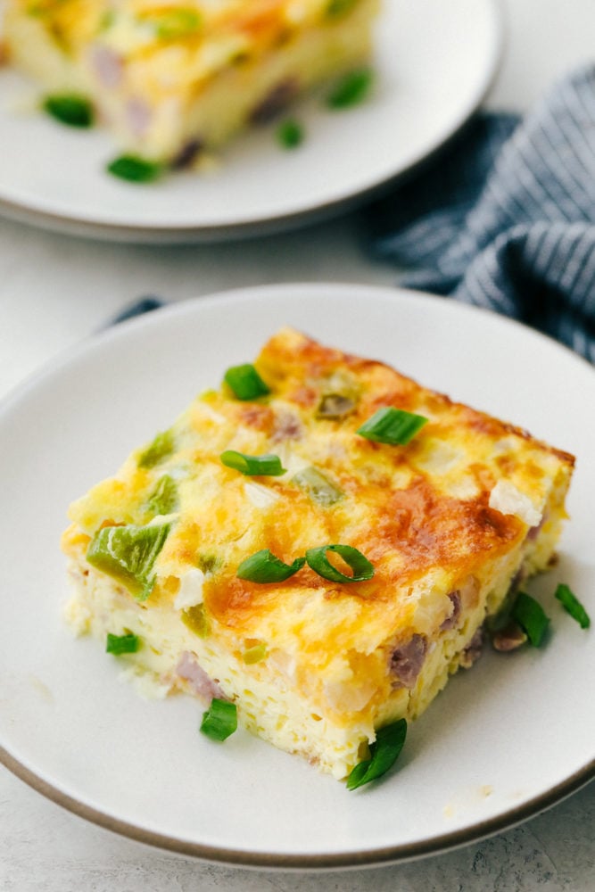 Denver omelet slice on a white plate.