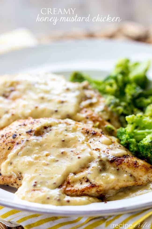 Creamy honey mustard chicken served on a plate with broccoli as a side dish. 
