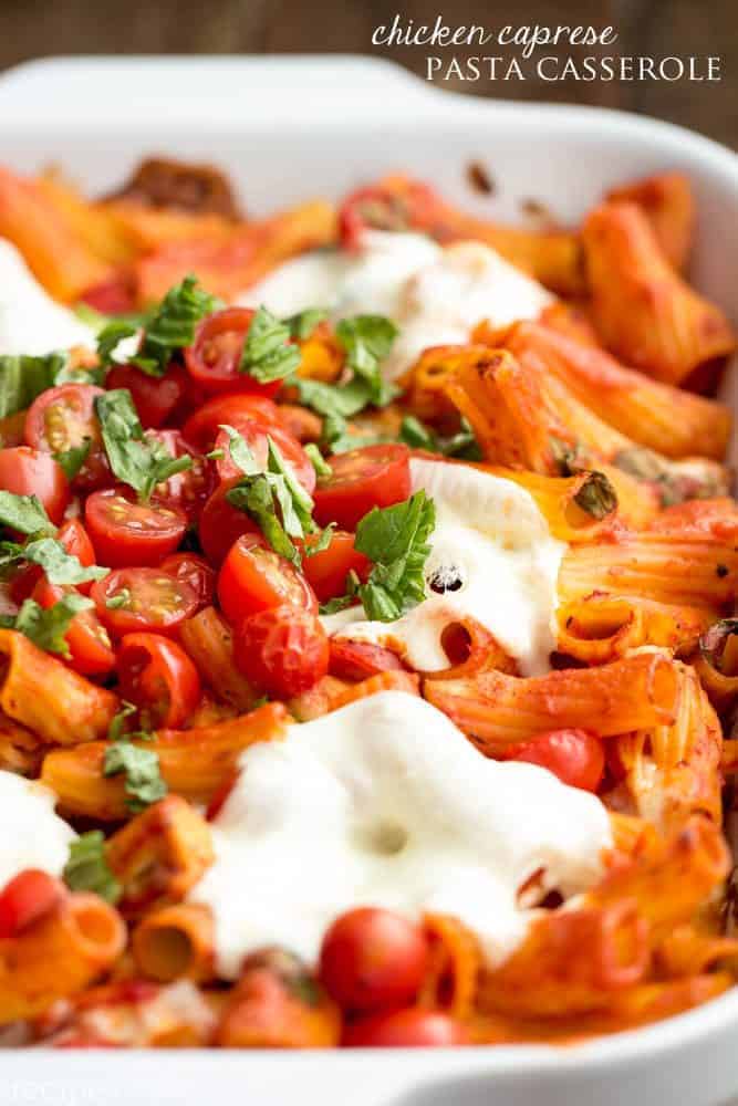 Chicken caprese pasta casserole in a white casserole dish. 