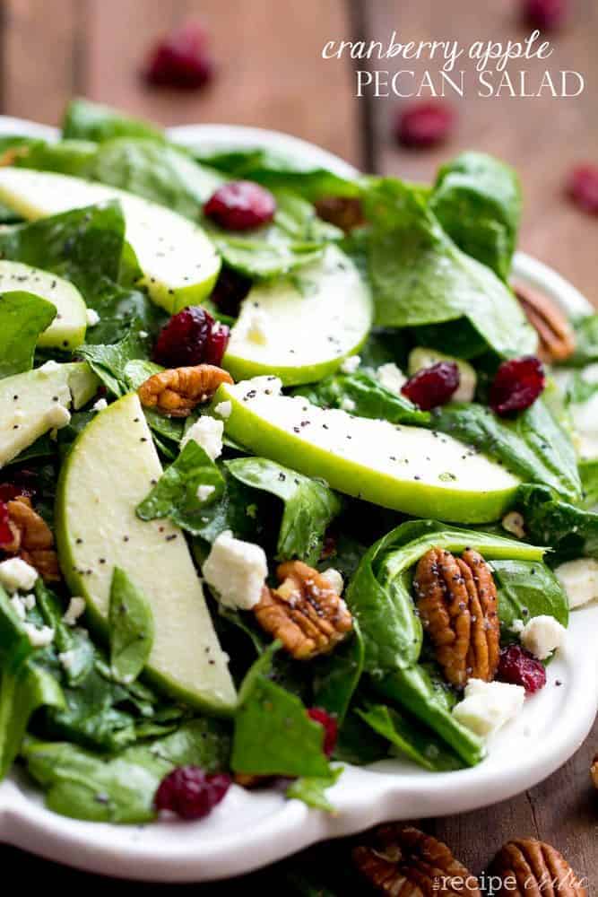 Cranberry apple pecan salad on a white plate.