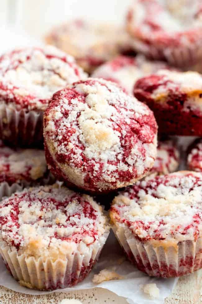 Red Velvet Cream Cheese Muffins that have been stacked on top of one another. 