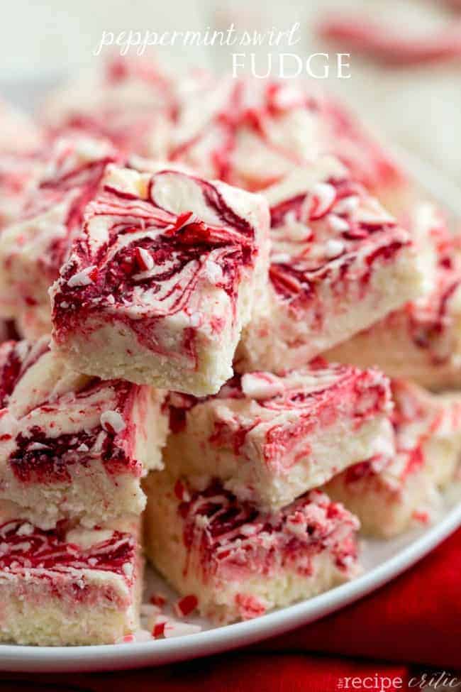 Peppermint fudge stacked on top of each other on a white plate. 