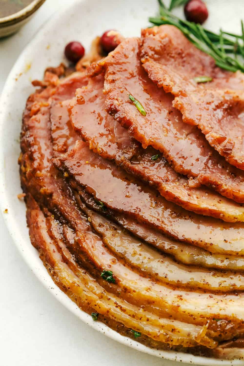 Slow Cooker Honey Garlic Mustard Glazed Ham sliced on a plate.