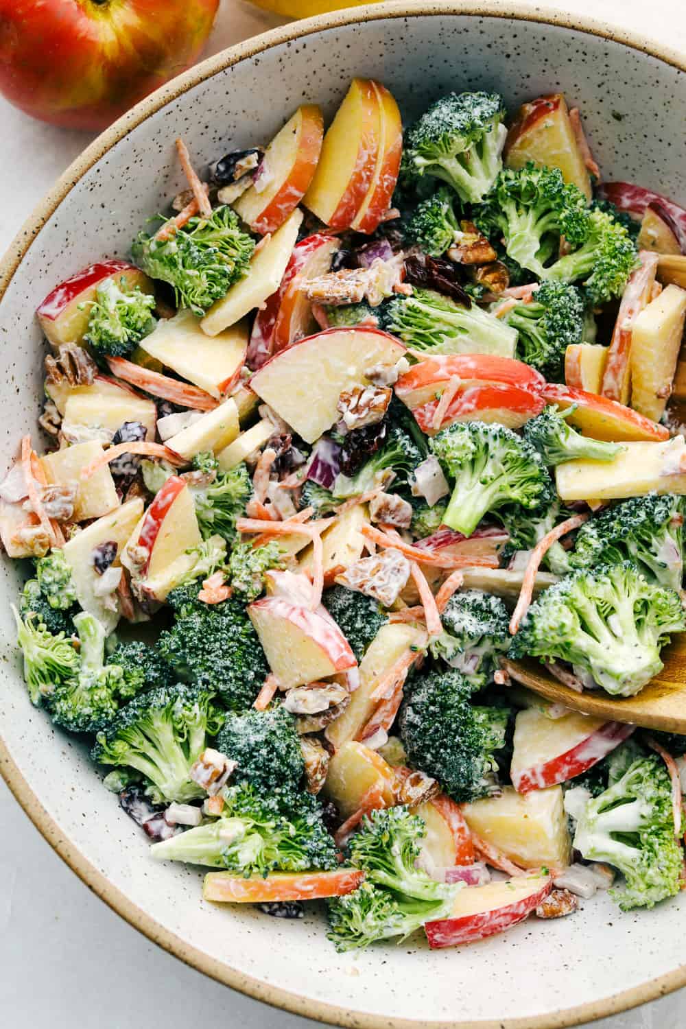 Broccoli and apple salad with a tangy dressing in a bowl. 