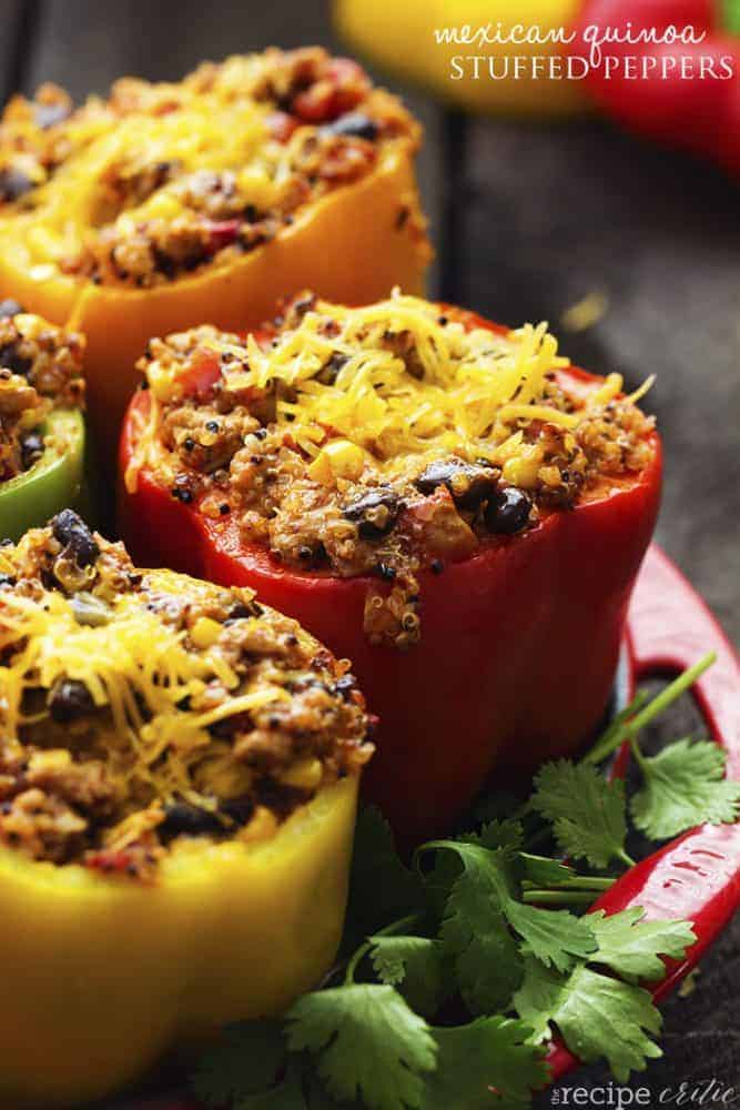 Mexican quinoa stuffed peppers on a red tray.