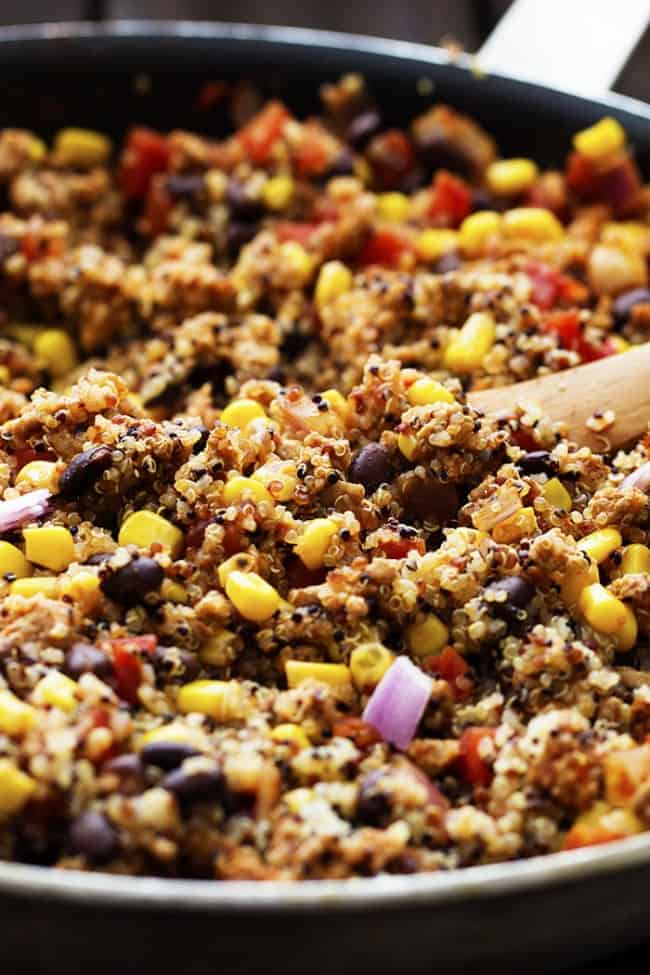 Mexican quinoa stuffing cooking in a skillet.