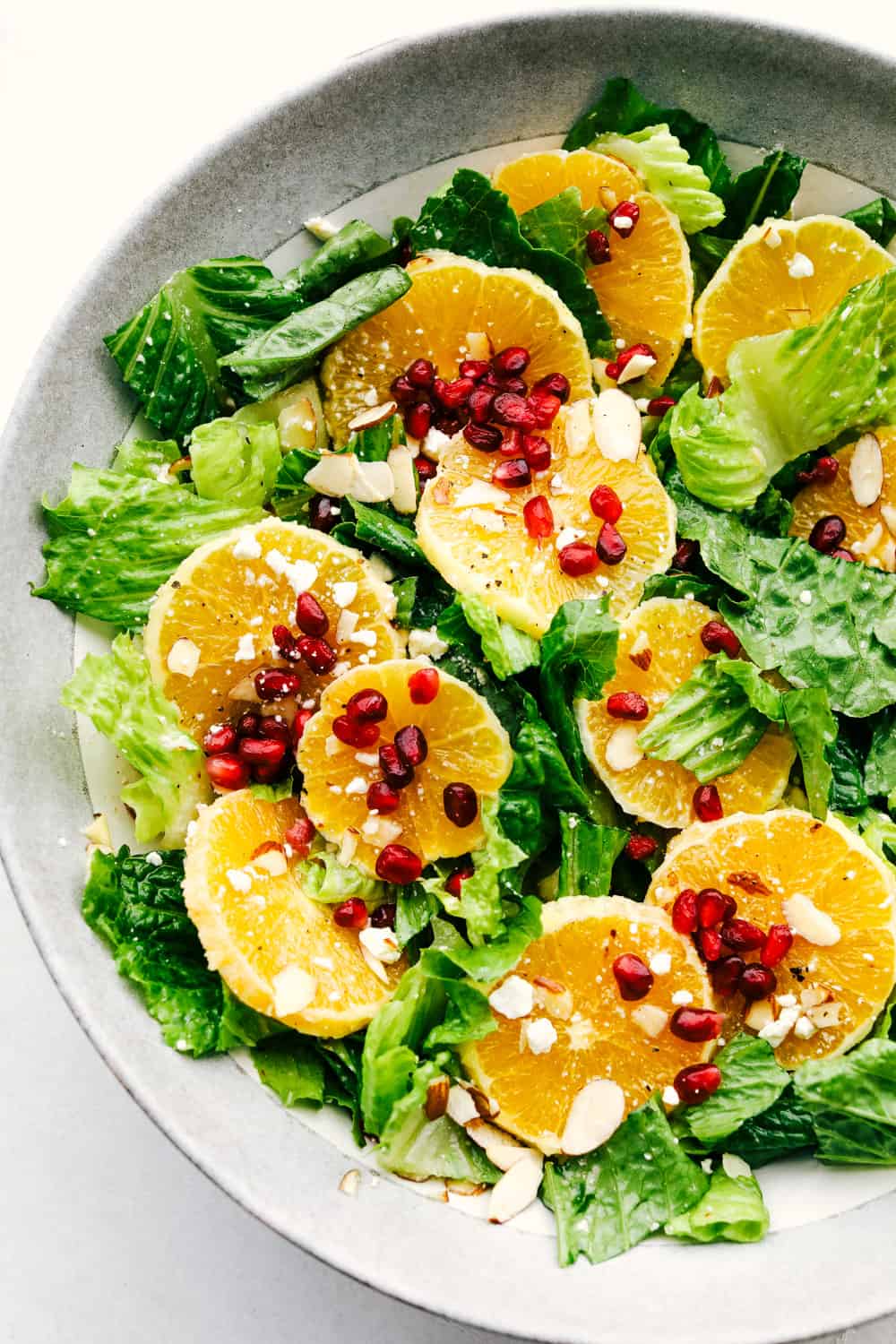 A salad with oranges and pomegranates and a zingy dressing. 