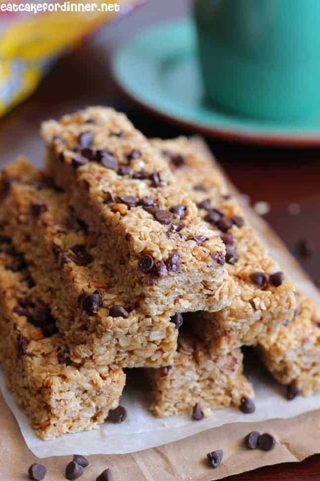 No bake peanut butter chocolate chip granola bars in a stack on a white plate.