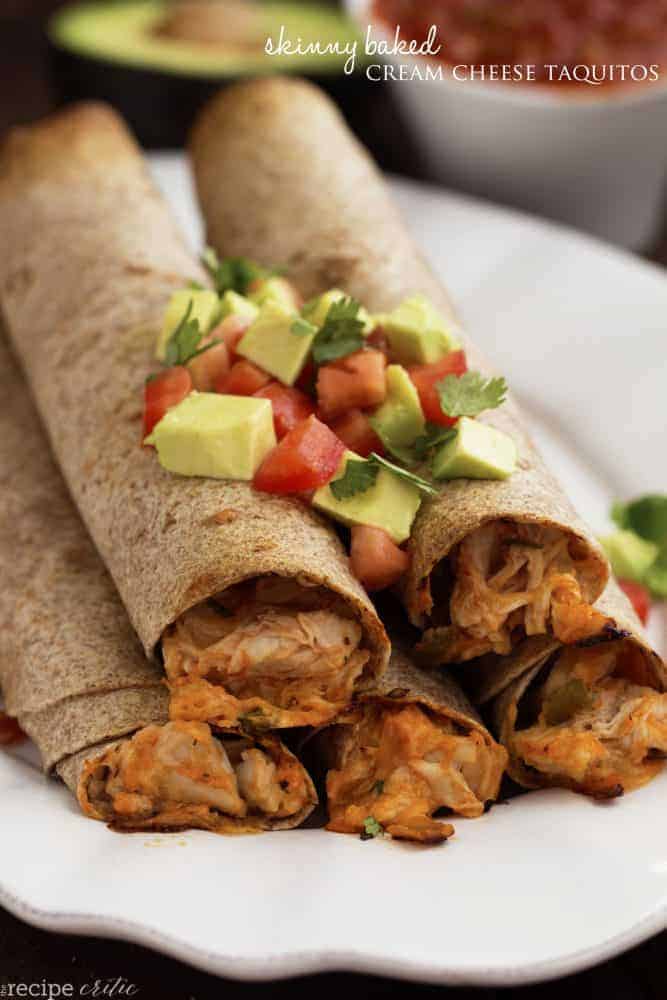 skinny baked cream cheese taquitos in a pyramid stack on a white plate.