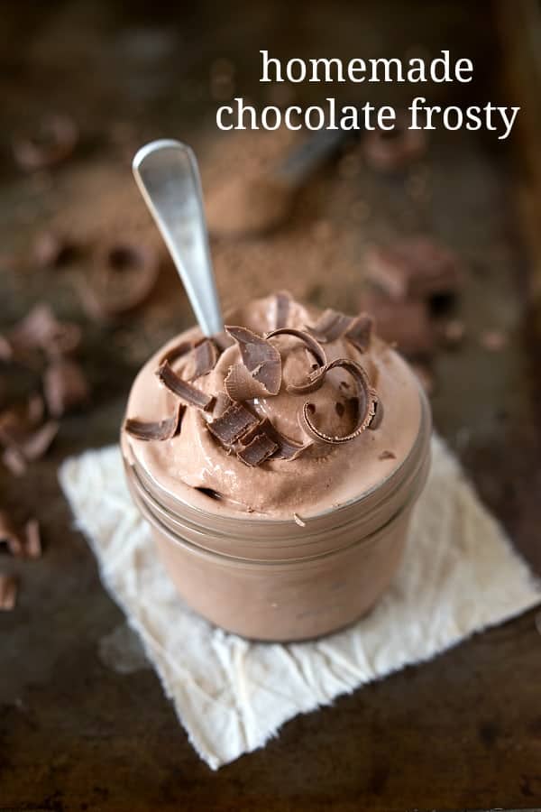 Homemade Frosty in a glass jar with a spoon and chocolate shavings.