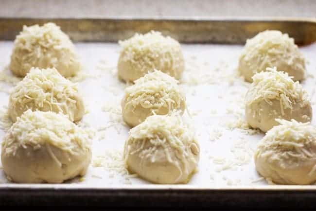 Asiago cheese rolls dough on a pan.