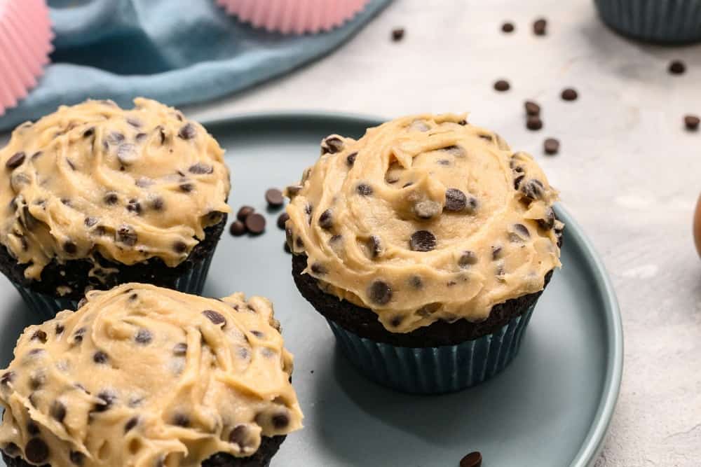 Chocolate cookie dough cupcakes on a platter.