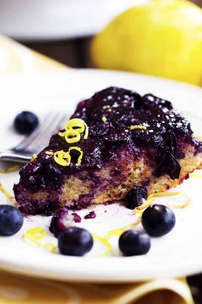 A slice of blueberry lemon upside down cake on a white plate.