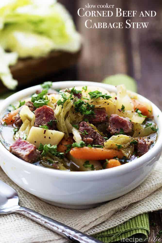 Corned beef cabbage stew in a white bowl.