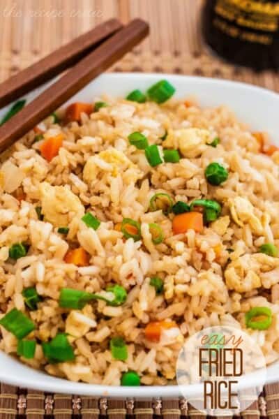 fried rice in a white bowl with chopsticks.