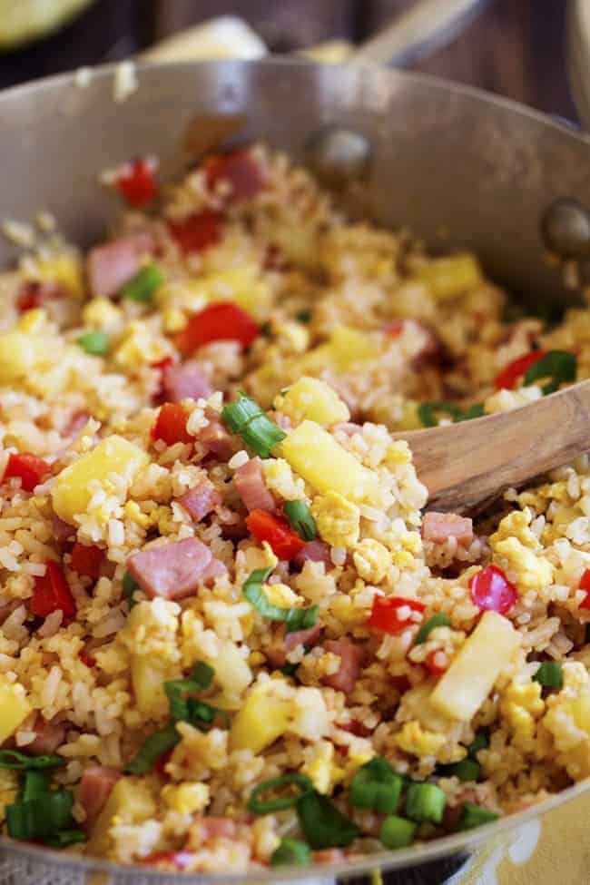 Stirring Hawaiian fried rice cooking in a pot.