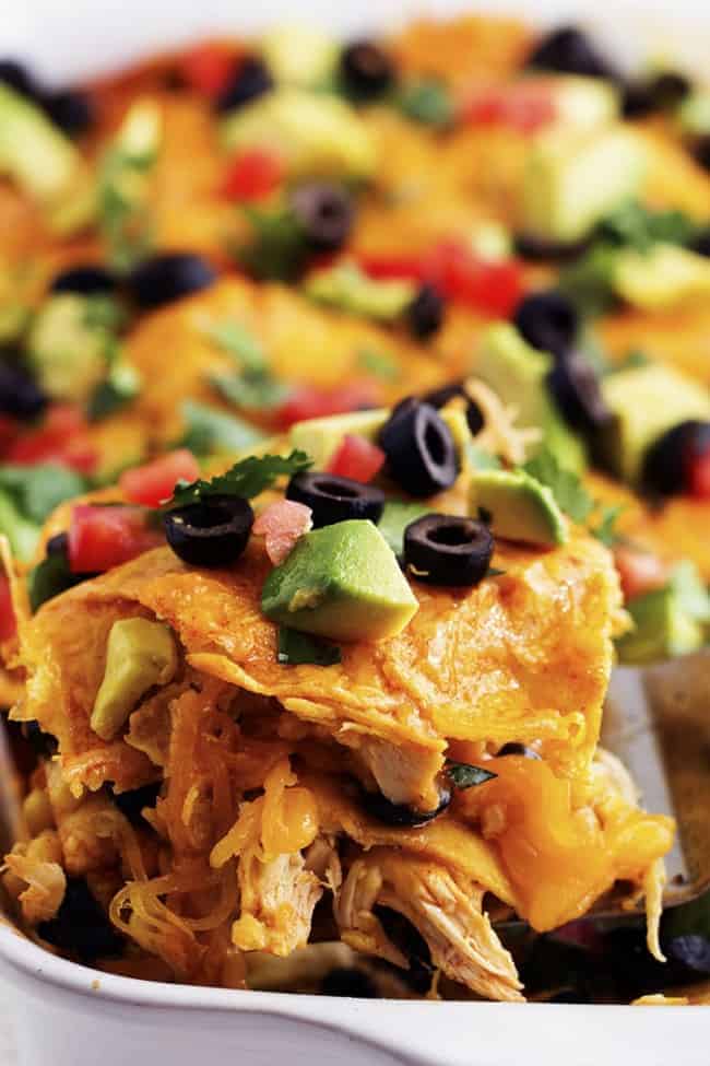 close up on a slice of stacked chicken enchiladas.