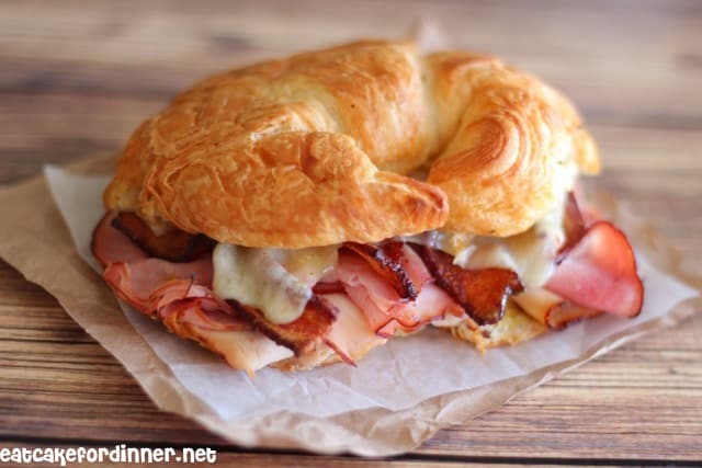 Ham, Turkey and Bacon Croissant Melt on a napkin