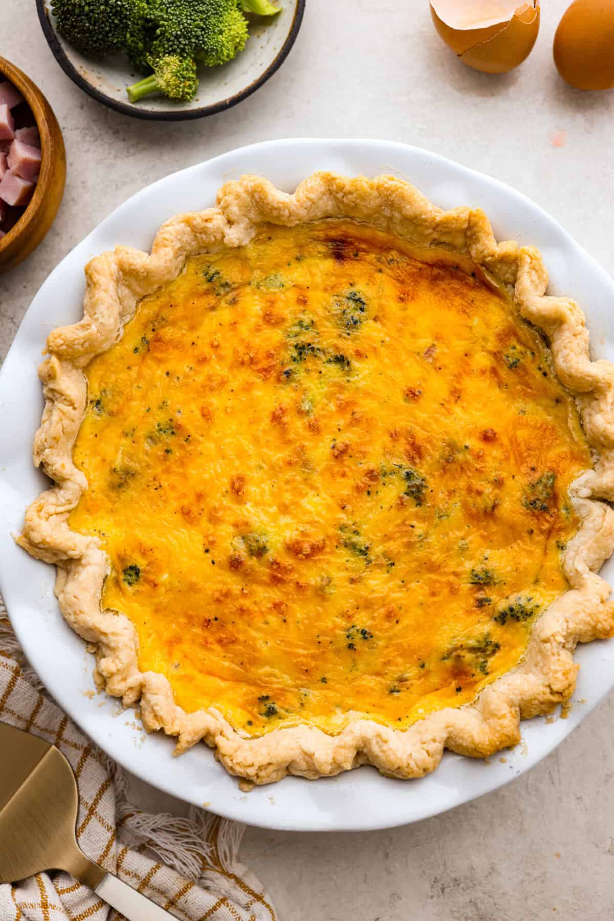 Overhead shot of baked ham and broccoli quiche. 