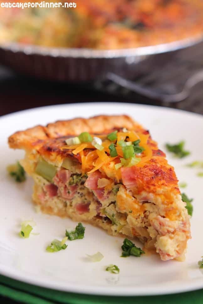 Ham and Broccoli Quiche slice on a white plate.