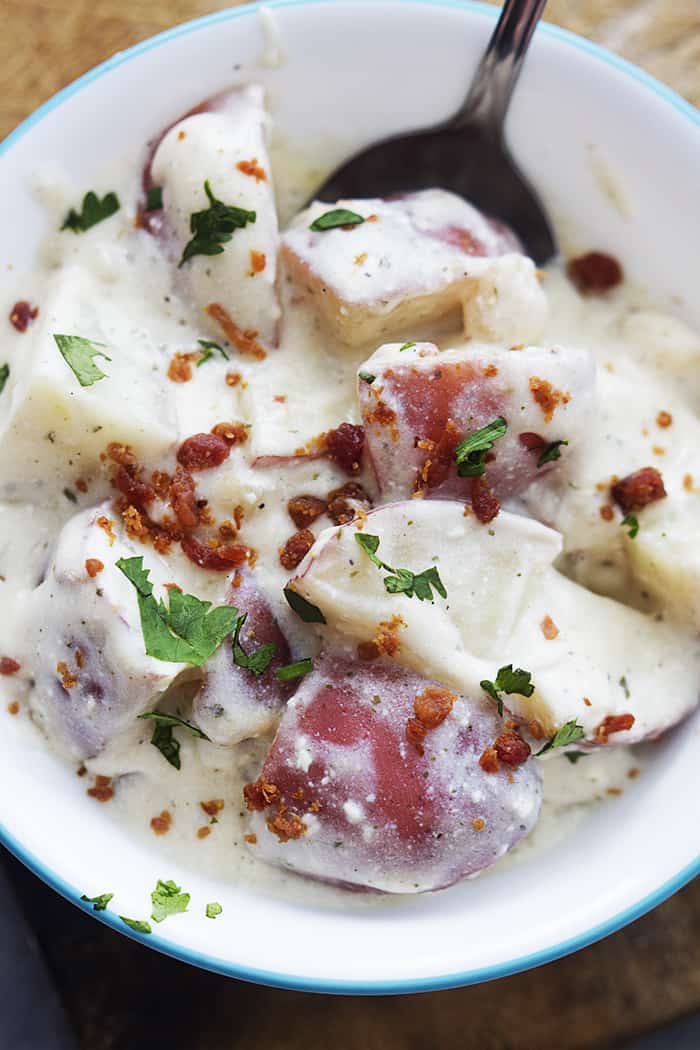 slow cooker ranch potatoes in a white bowl.