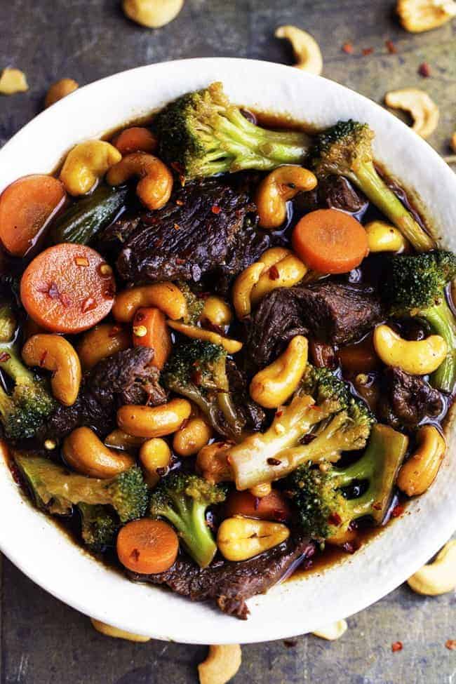 slow cooker cashew beef and broccoli in a white serving dish.