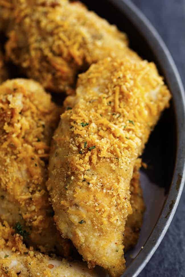 garlic cheddar chicken strips in a metal pan.