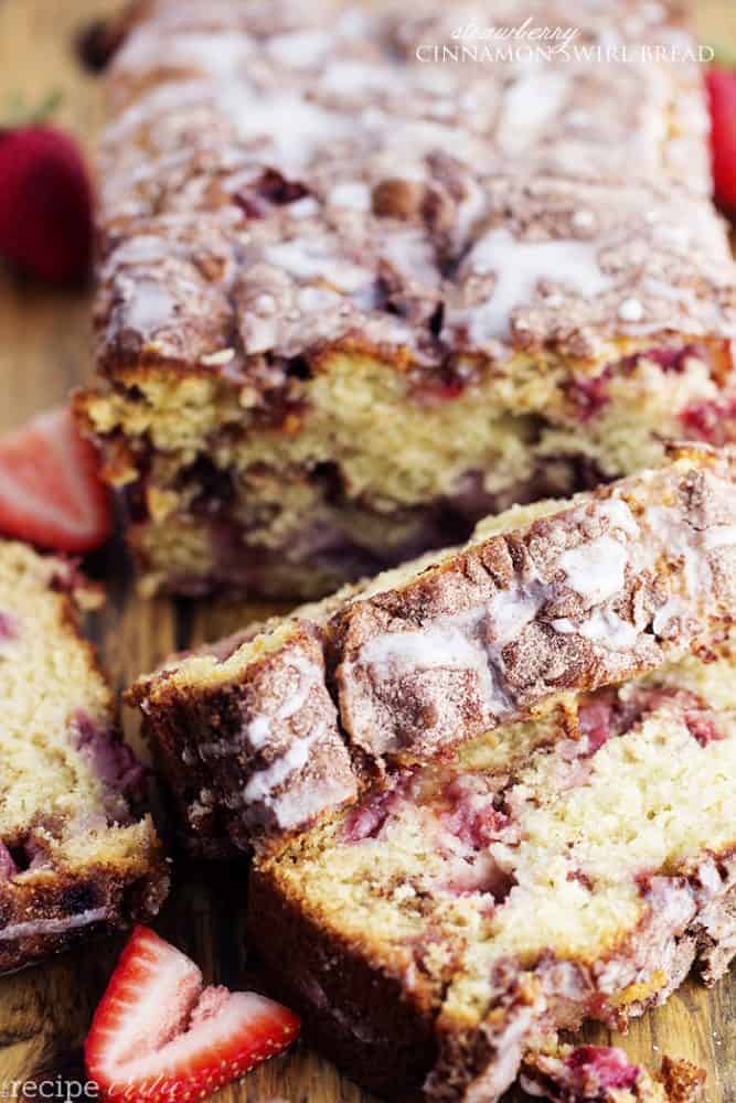 strawberry cinnamon swirl bread loaf with 2 sliced pieces.