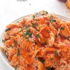 Slow Cooker Honey Sriracha Chicken - Moist and tender shredded chicken in an out-of-this world spicy and sweet sauce! Perfect for tacos, salads, or even sandwiches!