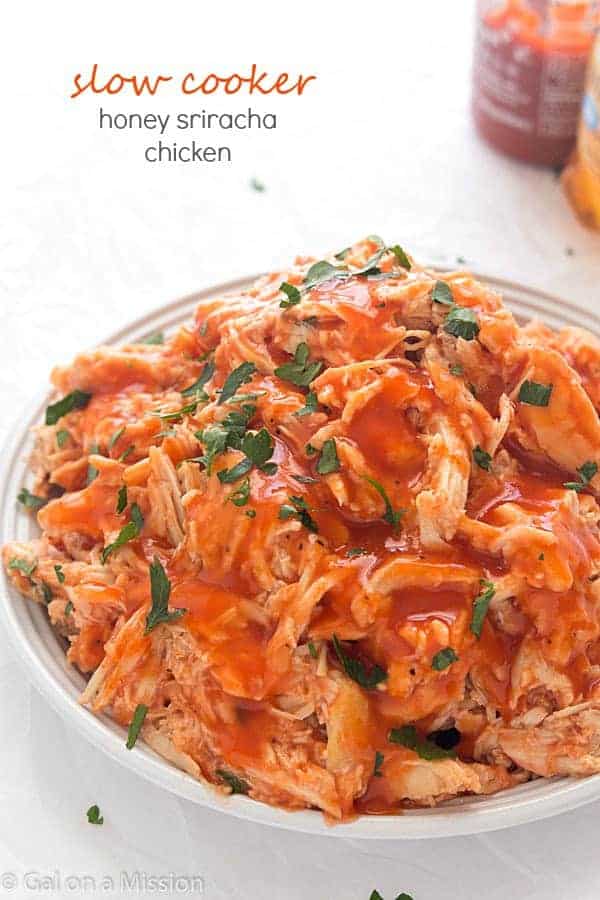 Slow Cooker Honey Sriracha Chicken - Moist and tender shredded chicken in an out-of-this world spicy and sweet sauce! Perfect for tacos, salads, or even sandwiches!