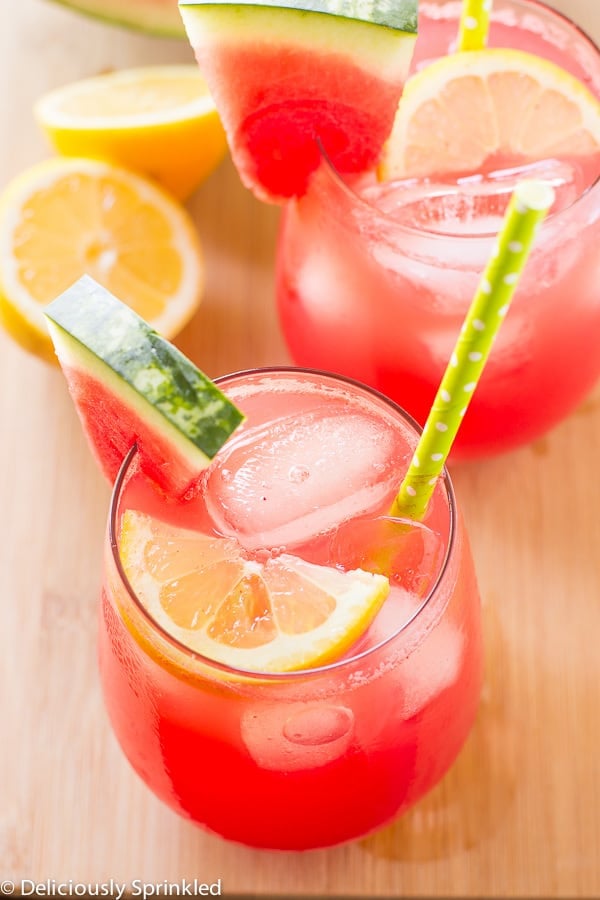 Watermelon Lemonade areal view with lemon, watermelon, ice and a lime green polka dot straw.