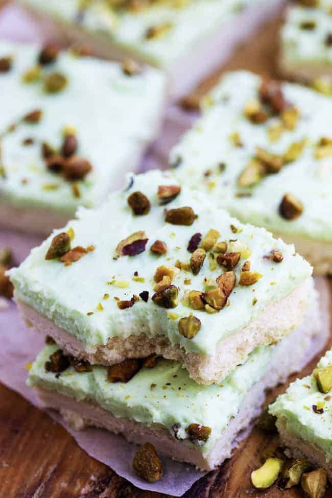 pistachio bars in a stack with a bite taken out of the top bar.