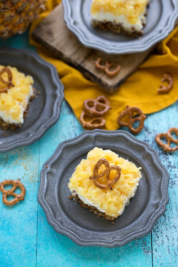 DELICIOUS Pineapple Cheesecake Pretzel Salad on a blue plate.