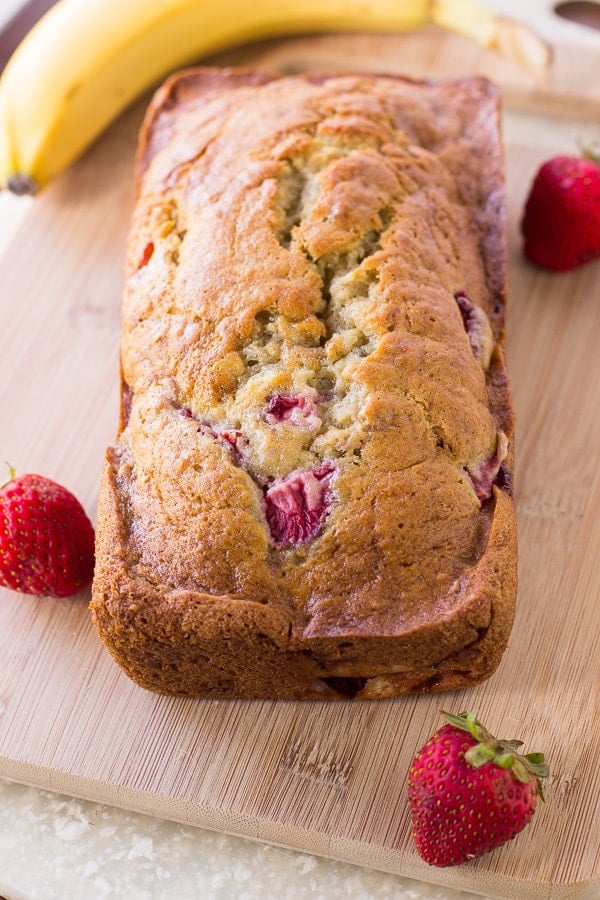 Strawberry Banana Bread loaf on a cutting board 