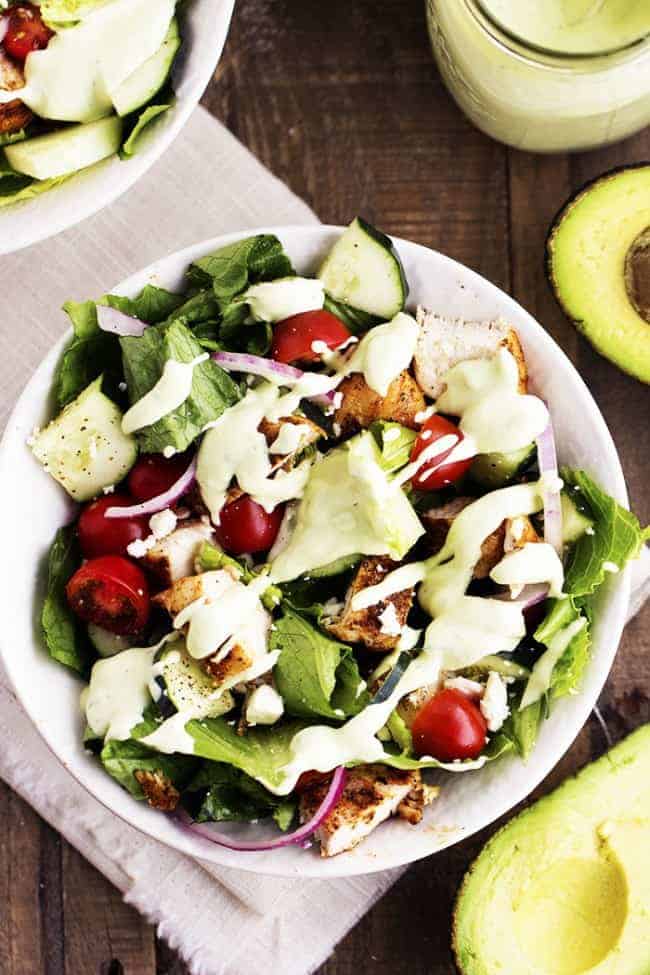 cajun chicken salad with avocado ranch dressing in a white bowl.