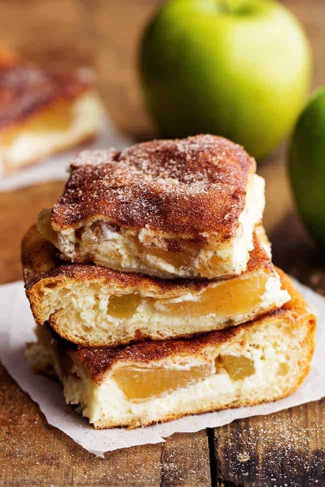 apple churro cheesecake bars in a stack.