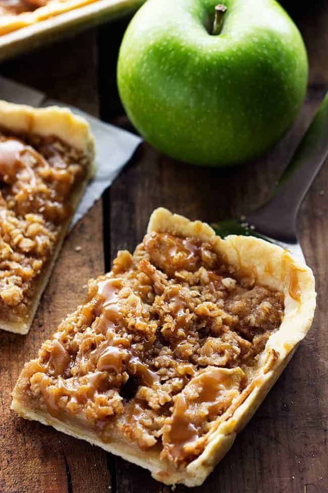 A square of caramel apples pie on a serving spoon.