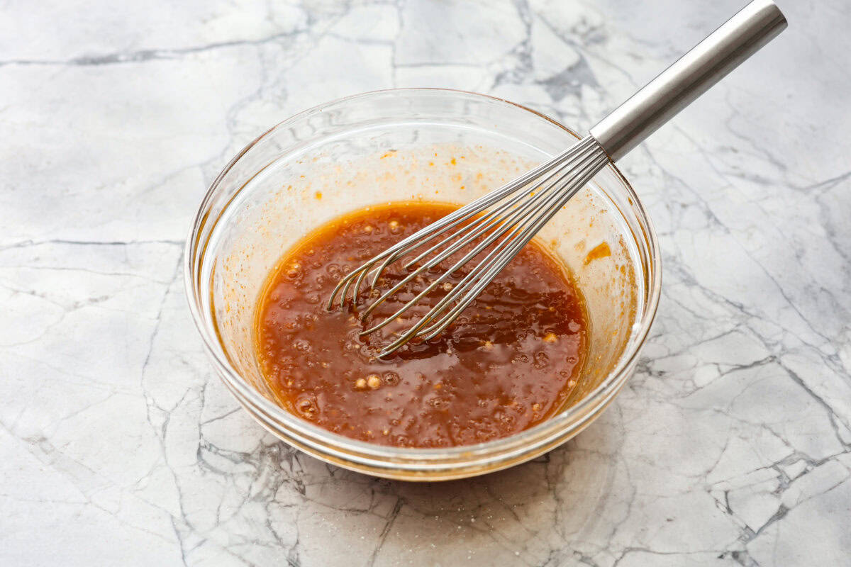 Overhead shot of sauce ingredients whisked together in a bowl. 