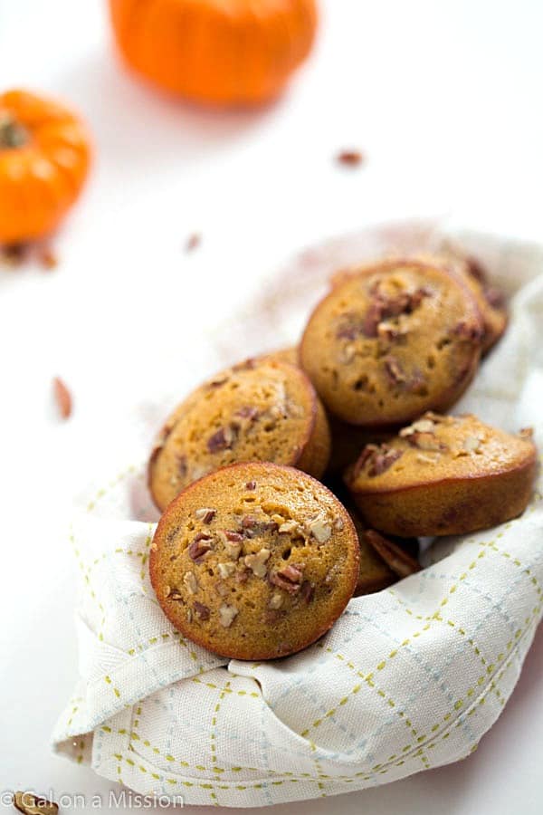 Pumpkin Pecan Pie Muffins in a basket with a white cloth.