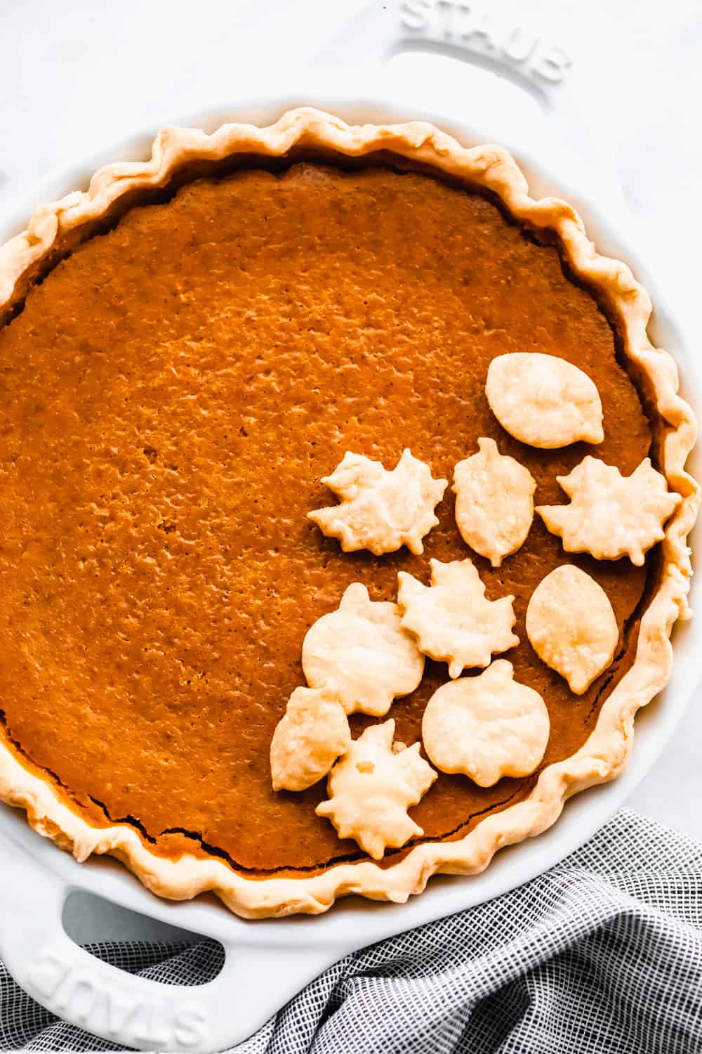 Baked pumpkin pie with decorative pie crust leaves
