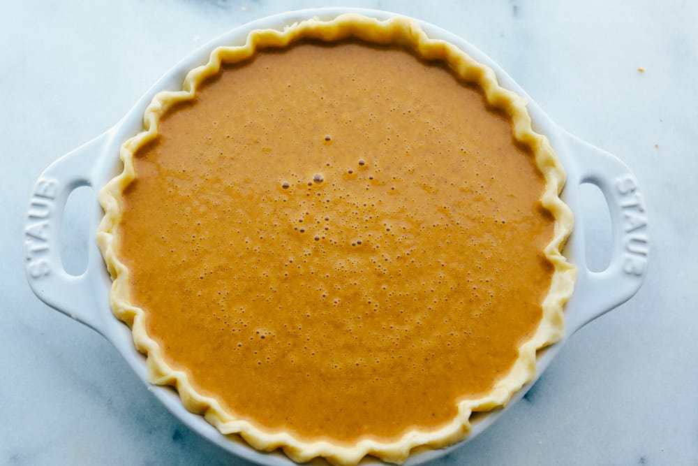 A pumpkin pie ready to bake