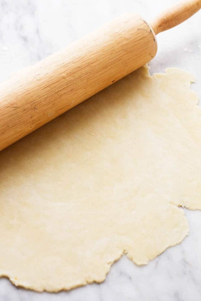Rolling out pie crust dough.