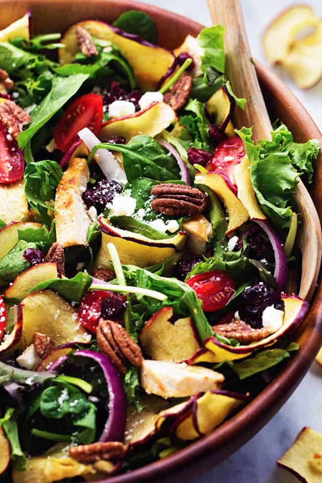 Fuji Apple Chicken Salad in a wooden bowl with a wooden spoon.