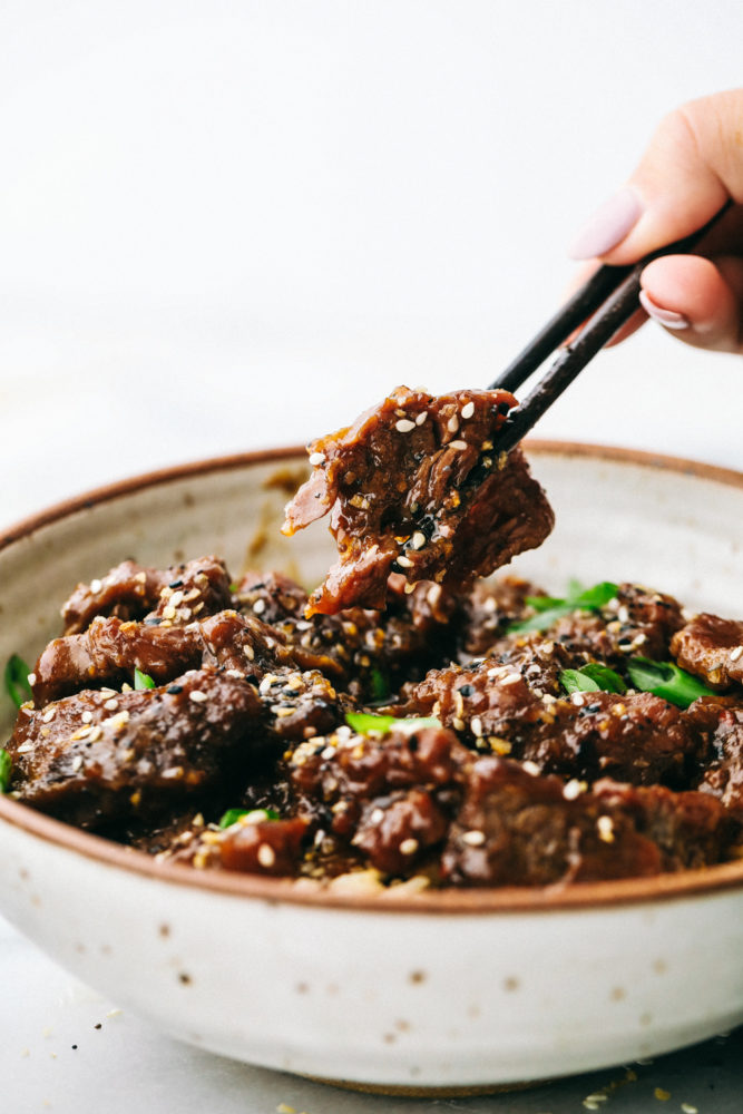 Korean beef in a bowl with black chopsticks. 