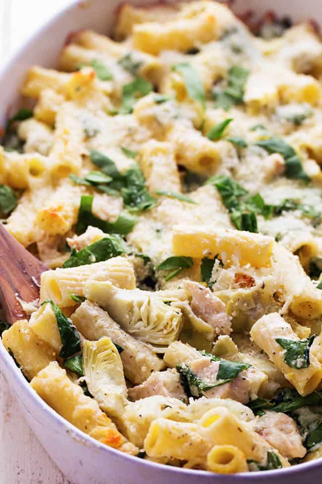 chicken spinach artichoke casserole in a white bowl.