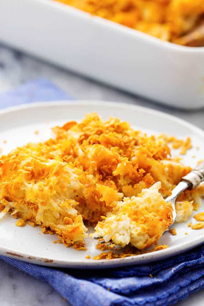 funeral potatoes on a white plate.