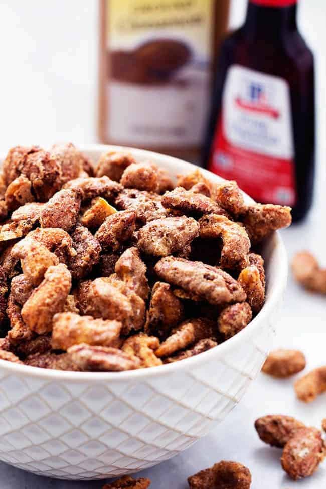 Roasted cinnamon sugar nuts in a white bowl.