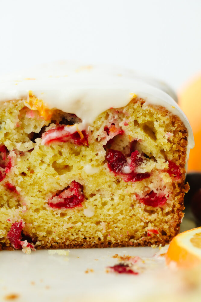A zoomed in picture showing the inside of cranberry orange quick bread. 